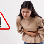 A woman holding her stomach in visible pain, with a warning sign next to her, symbolizing the harmful effects of navel misalignment on digestive and abdominal health.