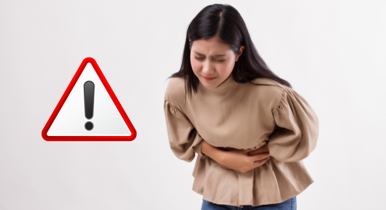 A woman holding her stomach in visible pain, with a warning sign next to her, symbolizing the harmful effects of navel misalignment on digestive and abdominal health.