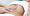 Person receiving a belly button massage with oil, a traditional Ayurvedic method to support digestion and detox