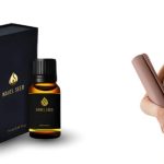 Woman holding a yoga mat and giving a thumbs up next to a bottle and box of navel seed oil, promoting wellness and daily self-care