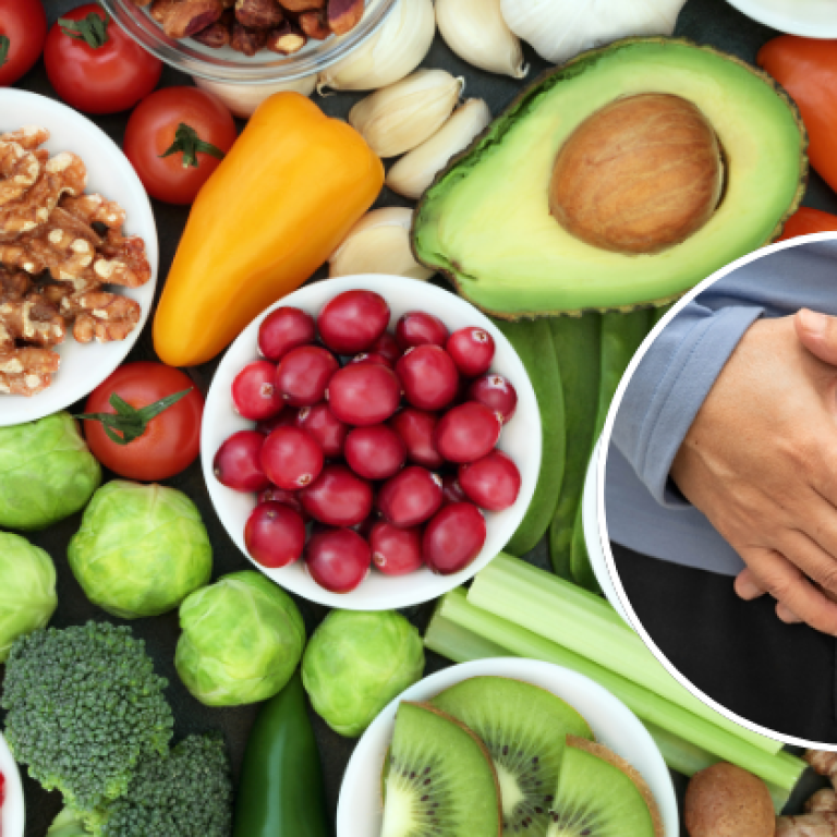 A variety of healthy, nutrient-rich foods such as fruits, vegetables, nuts, and seeds alongside an image of a person holding their abdomen, symbolizing the role of diet in navel displacement recovery.